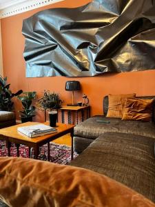 a living room with a couch and a painting on the wall at Spacious historical art oasis in the city center in Bergen