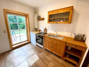 a kitchen with a sink and a stove at Tiny House Zur Alten Sparkasse in Groß Garz