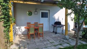 a table and chairs in front of a house at Pool place in Petrovče +10 photos