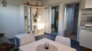 a kitchen and living room with a table and chairs at Pool place in Petrovče