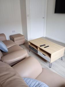 a living room with a couch and a coffee table at Mesnes Place in Wigan