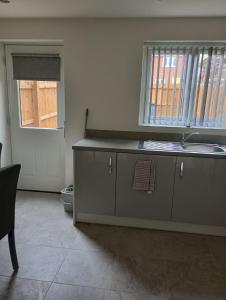 a kitchen with a sink and a counter top at Mesnes Place in Wigan