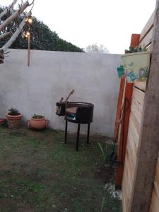 a grill in a yard next to a wall at FINCA los nogales in General Belgrano +5 photos