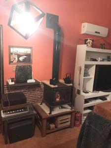 a living room with a fireplace and a stove at Mar de Ajo Norte, a 50 mts San Bernardo, Frente al Mar con Cochera in Mar de Ajó