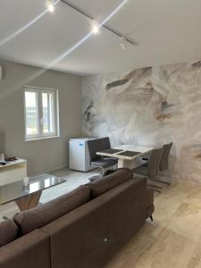a living room with a couch and a table at Apartman Linda in Cres