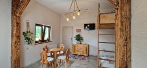 a room with a table and chairs and a bunk bed at Derkaczowa Kotlina in Gniewoszów