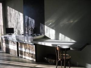 a kitchen with a counter with a chair and a sink at Residenza Rosso Di Sera in Capoliveri +77 photos