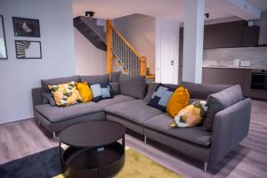 a living room with a couch and a staircase at Vila Happy Busteni in Buşteni
