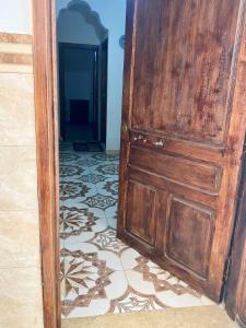 a wooden door in a room with a tile floor at Seabreeze House in Oued Laou