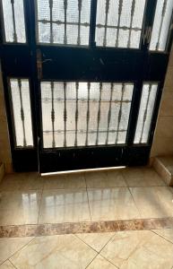 an open door with a gate in a room at Seabreeze House in Oued Laou +3 photos