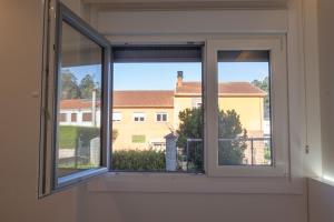 a window with a view of a building at Rest Pedrouzo in O Pedrouzo