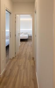 an empty room with a hallway with wood floors at Rest Pedrouzo in O Pedrouzo