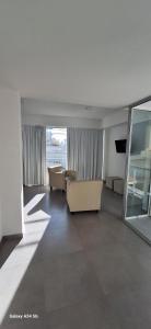 a living room with a couch and a table at Amanecerpuertomadryn 1 in Puerto Madryn