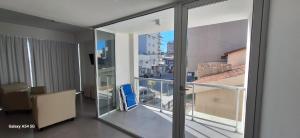 a room with a balcony with a view of a city at Amanecerpuertomadryn 1 in Puerto Madryn