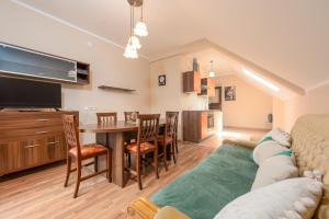 a living room with a couch and a table at Haus Rose in Gornji Prozor