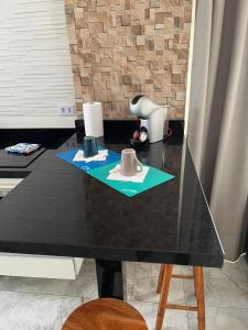 a black table with a hair dryer on top of it at Apartamento Paraíso da Ilha Porchat ! *Novíssimo!* in São Vicente