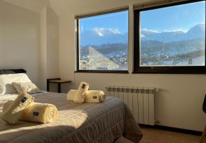 ein Schlafzimmer mit einem Bett und einem großen Fenster in der Unterkunft Al fin un mundo in Ushuaia
