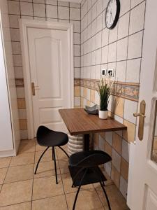 a kitchen with a table and two chairs and a clock at M&P Nuevo in Bilbao +10 photos