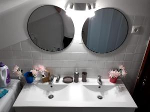 a bathroom with two sinks and two mirrors at Aroma das Tílias in Proença-a-Nova +49 photos