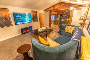 a living room with a blue couch and a tv at Las Vegas Oasis Home Primary in Las Vegas