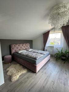 a bedroom with a large bed and a large window at Cozy Getaway near Palanga in Kretinga