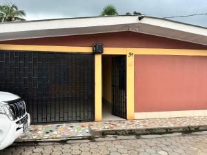 a small house with a gate and a garage at Havana in Rivas