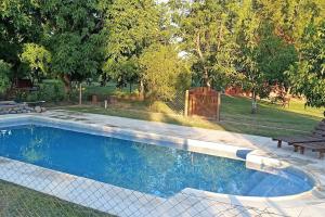 a swimming pool in a yard with a bench at La casita Espiritual in San Rafael +6 photos
