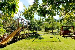 a park with a swing set in the grass at La casita Espiritual in San Rafael