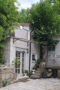 a white brick house with a balcony and stairs at Apartments with swimming pool Juradi, Central Istria - Sredisnja Istra - 21453 in Buzet