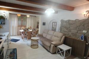 a living room with a couch and a stone wall at Apartments with swimming pool Juradi, Central Istria - Sredisnja Istra - 21453 in Buzet