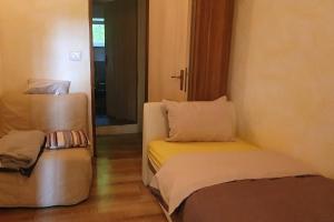 a small room with a bed and a chair at Apartments with swimming pool Juradi, Central Istria - Sredisnja Istra - 21453 in Buzet