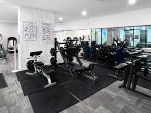 a gym with several treadmills and exercise bikes at Incredible ocean views 3 Bed 18th floor in Gold Coast