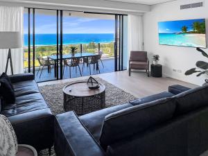 a living room with a couch and a table at Incredible ocean views 3 Bed 18th floor in Gold Coast