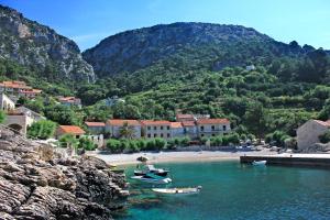 a group of boats in a body of water with mountains at Seaside holiday house Podobuce, Peljesac - 23460 in Orebić