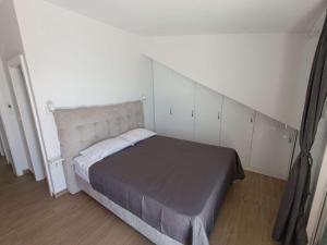 a bedroom with a bed with a large headboard at Seaside holiday house Podobuce, Peljesac - 23460 in Orebić