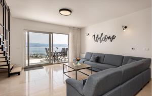 a living room with a couch and a table at Amazing Apartment In Icici With Kitchen in Ičići