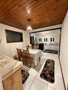 een eetkamer met een tafel en een keuken bij Residencial Casuarina Monte Verde in Camanducaia