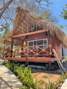 a small hut with a thatched roof at Cabaña Tulipan Punto surf Barra La Saladita in La Salada