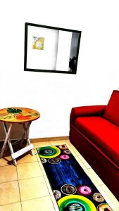 a living room with a red couch and a table at Apartamento POSADAS in Posadas +2 photos