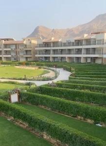 an apartment complex with a garden in front of a building at Ain Sokhna Chalet in Ain Sokhna