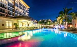 a large swimming pool in front of a building at Kata Beach Guesthouse-The Beach Condo in Kata Beach
