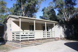 a small white house with a large porch at BIG4 Seymour Holiday Park in Seymour