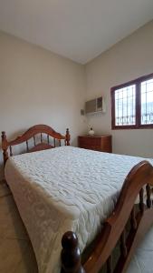 a bedroom with a large wooden bed in a room at La casa de los abuelos in Santiago del Estero