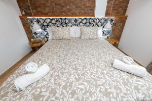a bedroom with a large bed with two pillows at Calas Beach Corralejo in Corralejo