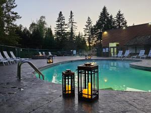 a swimming pool with lights and chairs around it at Superior Shores Resort in Two Harbors