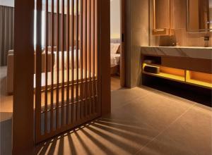a door with a gate in a room at Yanyu Yunxi Resort Hotel 烟雨云兮酒店 in Fenghuang County