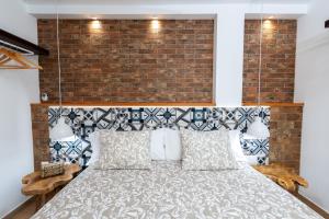 a bedroom with a bed with a brick wall at Calas Beach Corralejo in Corralejo