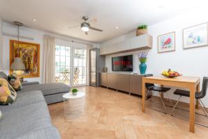 a living room with a couch and a table at Calas Beach Corralejo in Corralejo