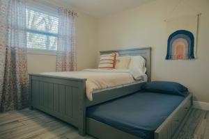 a childs bedroom with a bed and a window at 2 homes within 5 miles of each other, one on Lake in Lutz