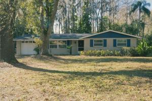 a house with a tree in front of a yard at 2 homes within 5 miles of each other, one on Lake in Lutz